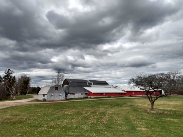 an old barn with stormy skies
